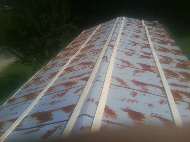 Rusted metal roof panels with new wood purlins before replacement — Storm Damage Roof Repair in Point Marion by Roofing Brothers